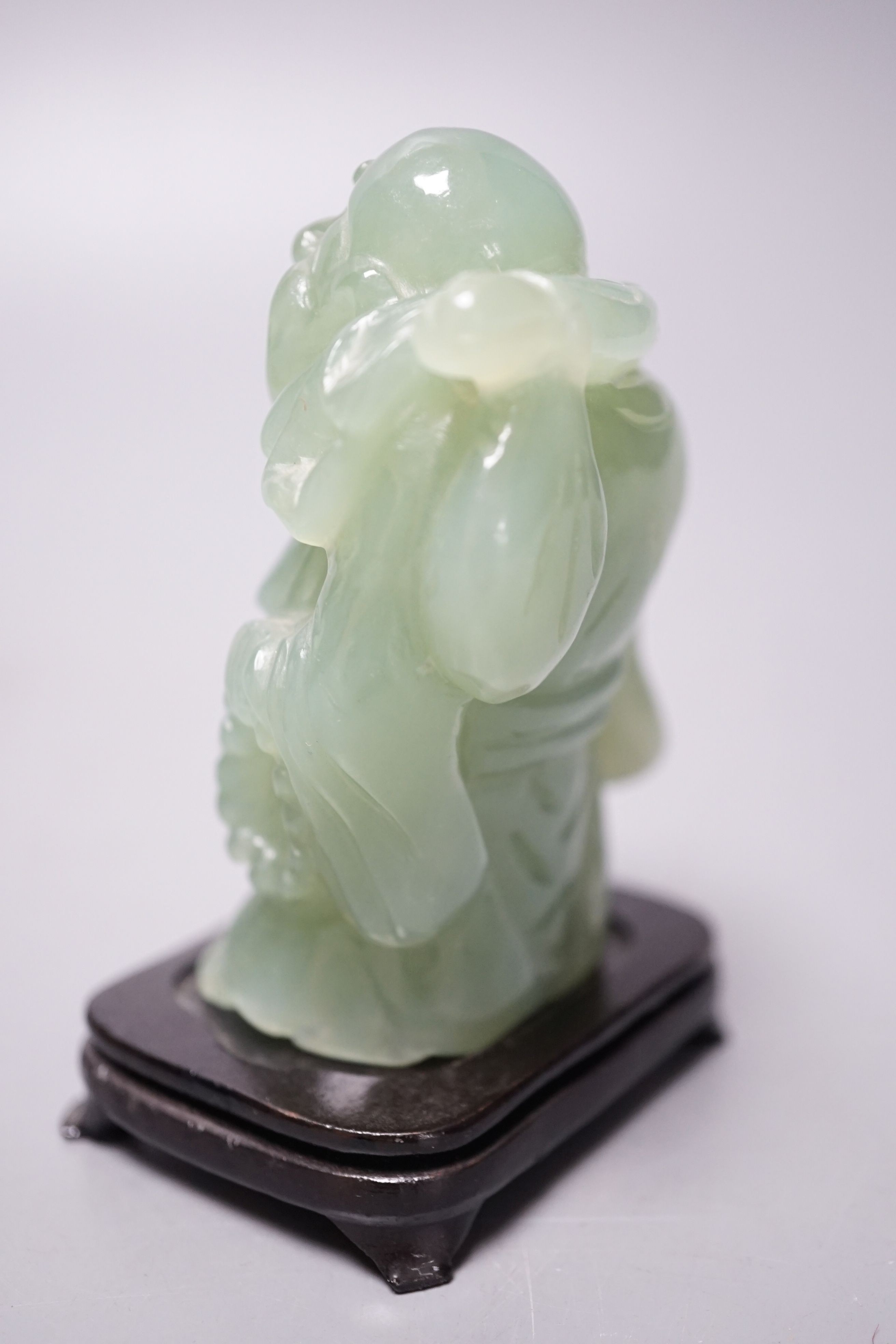 Two bowenite carvings of an elephant and Budai, wood stands, tallest, 9.5cm